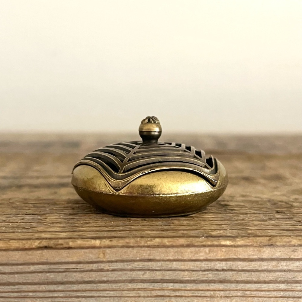 Brass spiderweb incense holder.